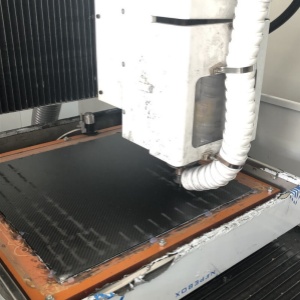 CNC routing carbon fiber drone frames with high precision.